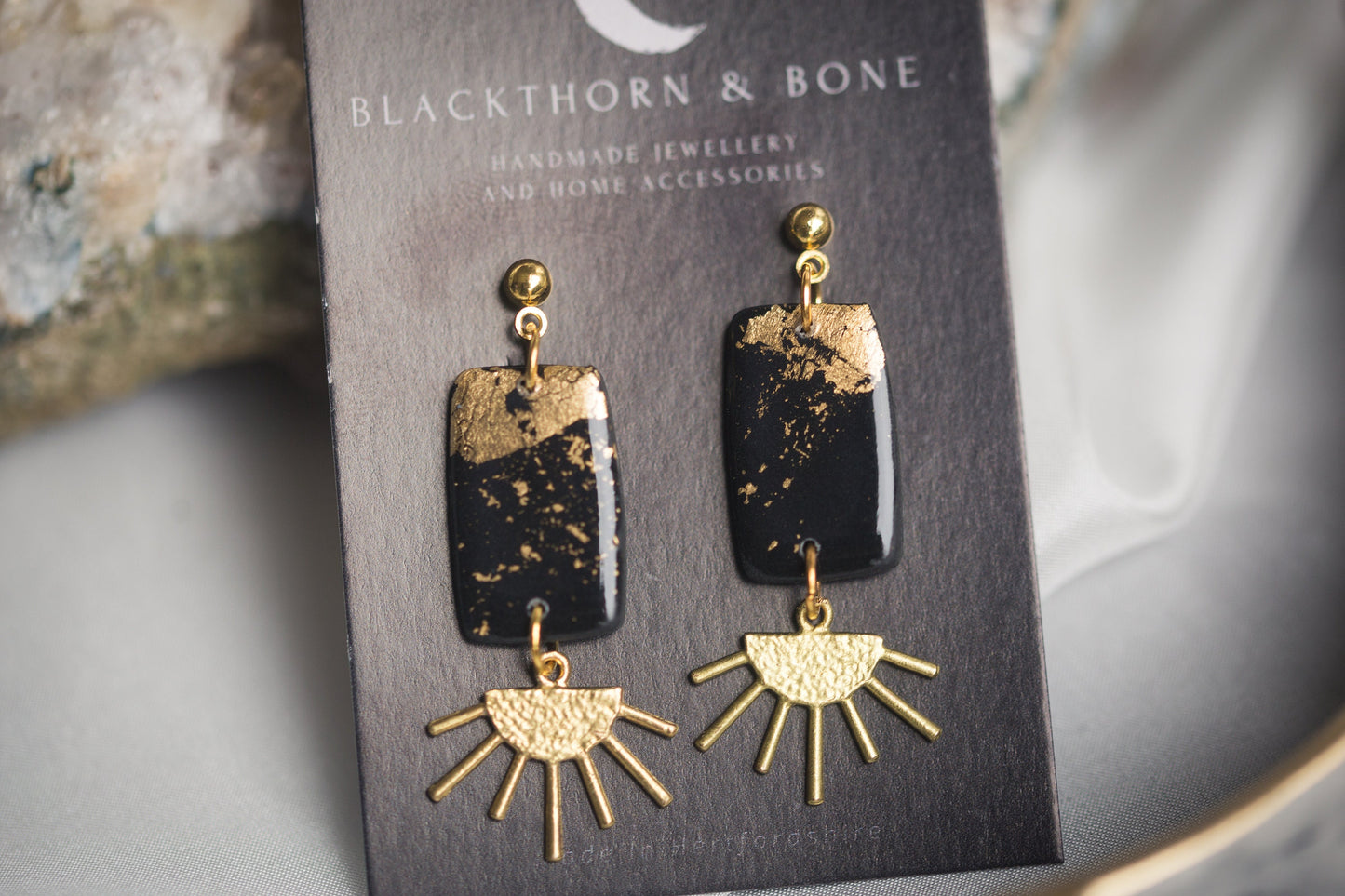 Black and Gold Clay Earrings with Brass Sun Charm