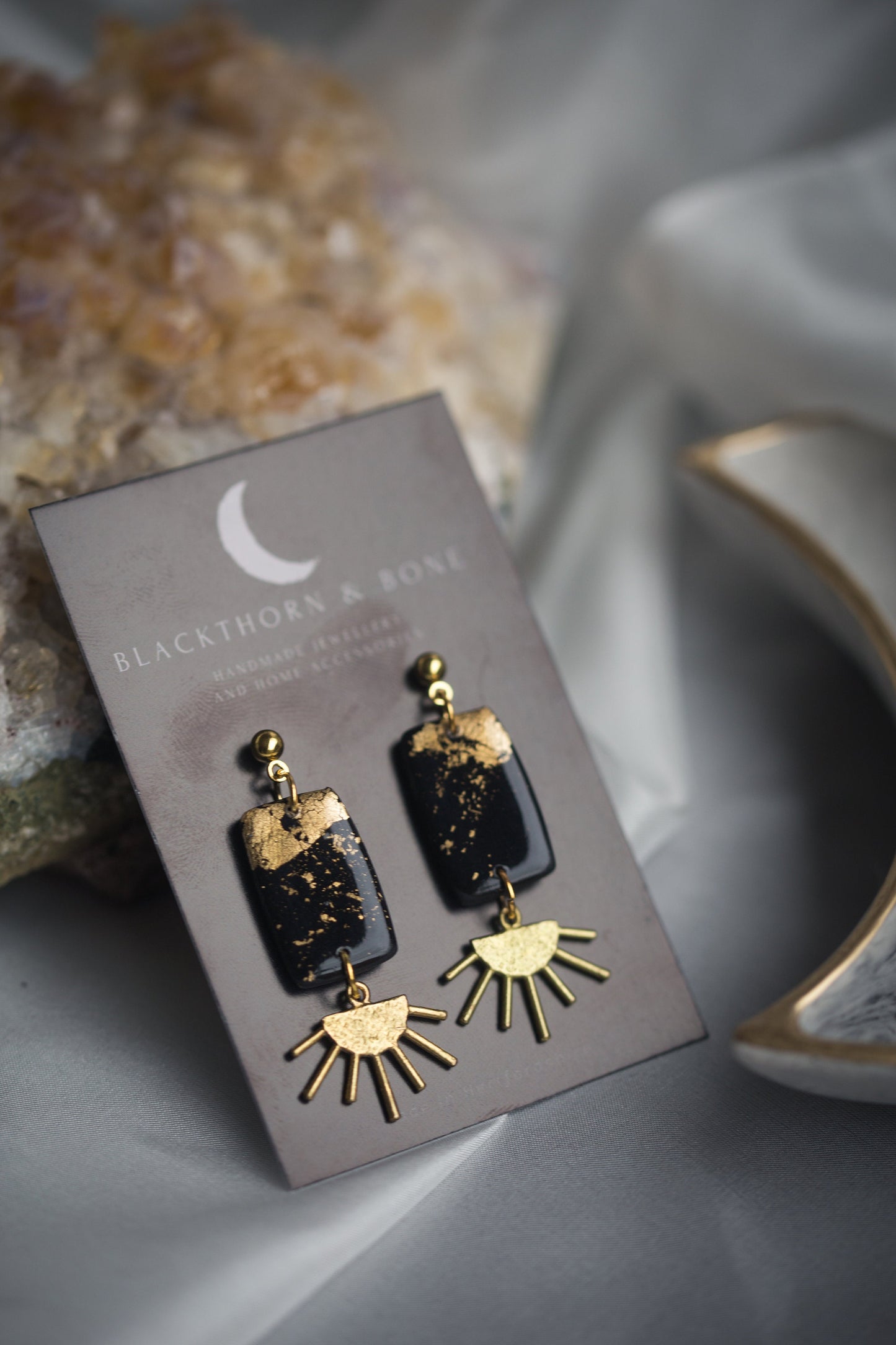 Black and Gold Clay Earrings with Brass Sun Charm