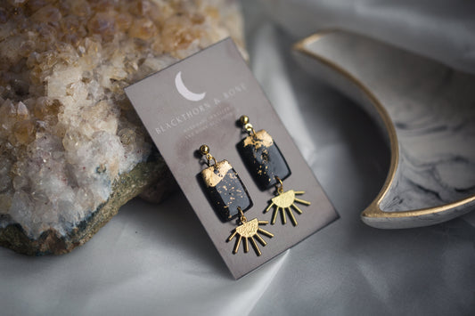 Black and Gold Clay Earrings with Brass Sun Charm