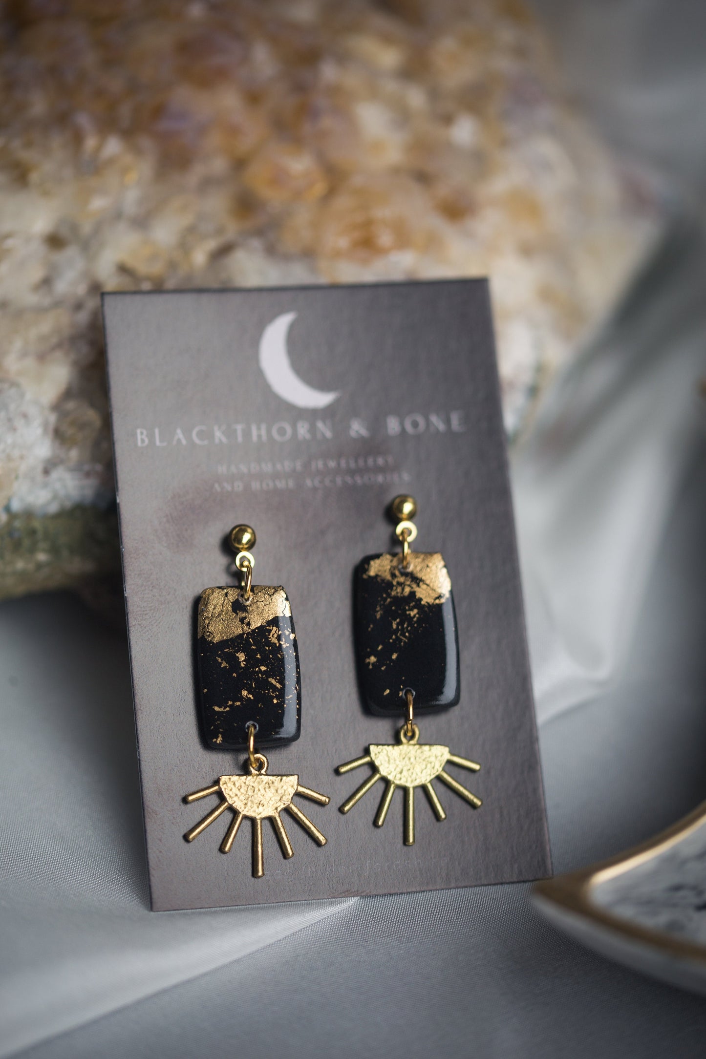 Black and Gold Clay Earrings with Brass Sun Charm